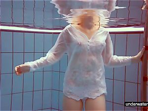 cute red-haired plays naked underwater